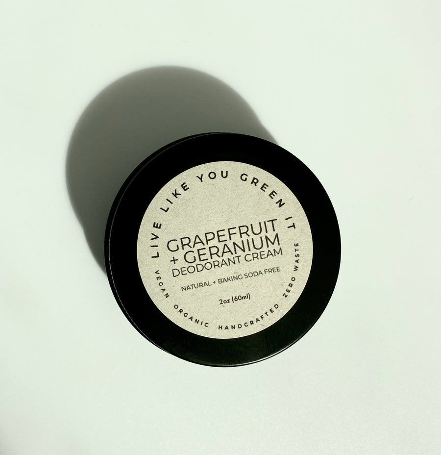 Black Tin of Live Like You Green It's Grapefruit + Geranium Deodorant Cream with tan sticker on top that reads 